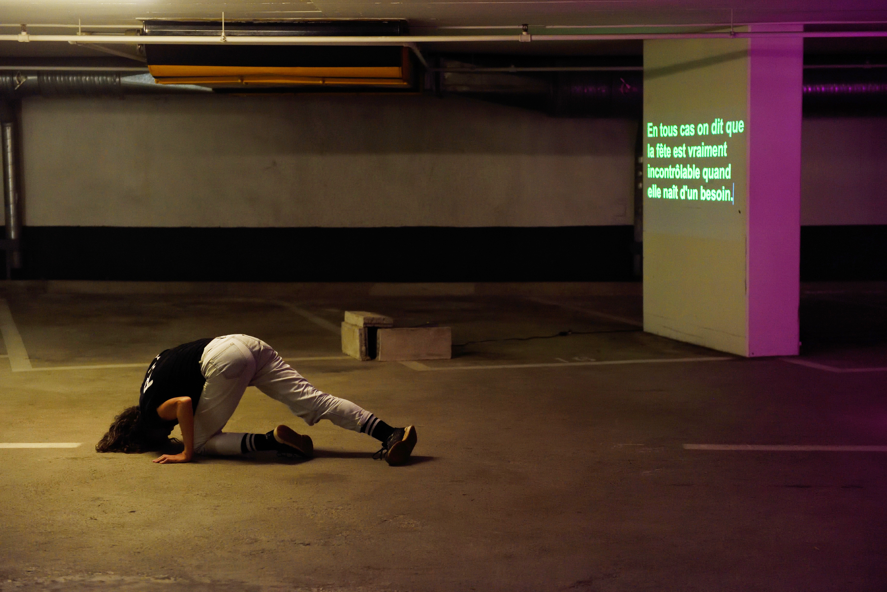 A person dancing in a parking lot