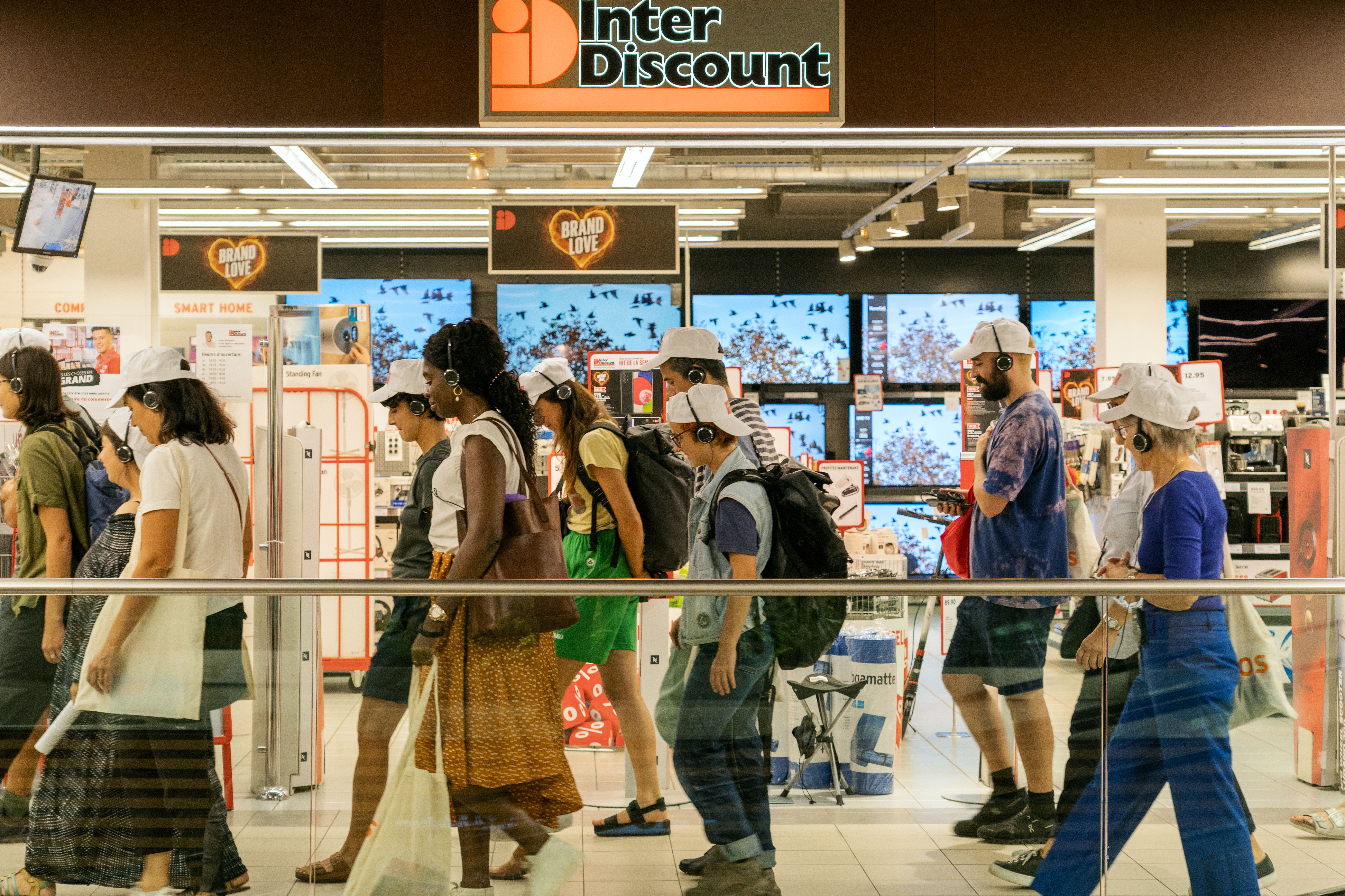 A group of people walking in a store